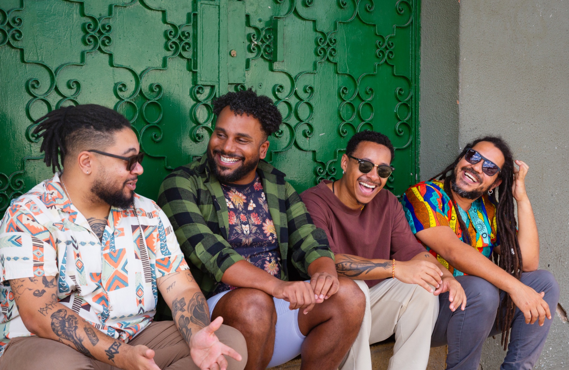 Group of professionals laughing together in front of a green carved door